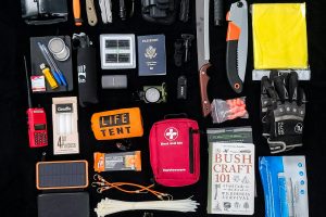pexels-photo-6608038-6608038 Survival gear essentials arranged as a flat lay for camping and hiking preparedness.